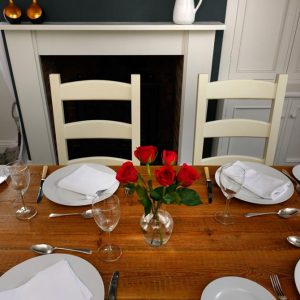 roses and set places on reclaimed wood table