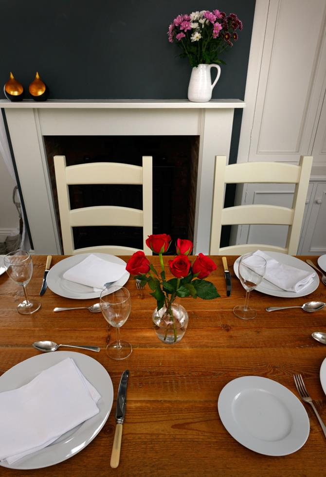 roses and set places on reclaimed wood table