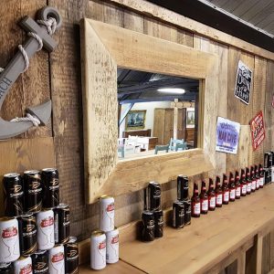 rustic wood mirror behind reclaimed wood bar
