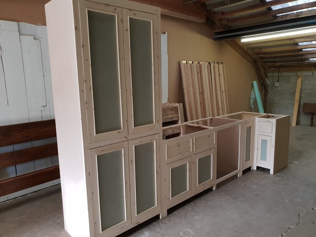 Trial run in workshop of large rustic wood kitchen units