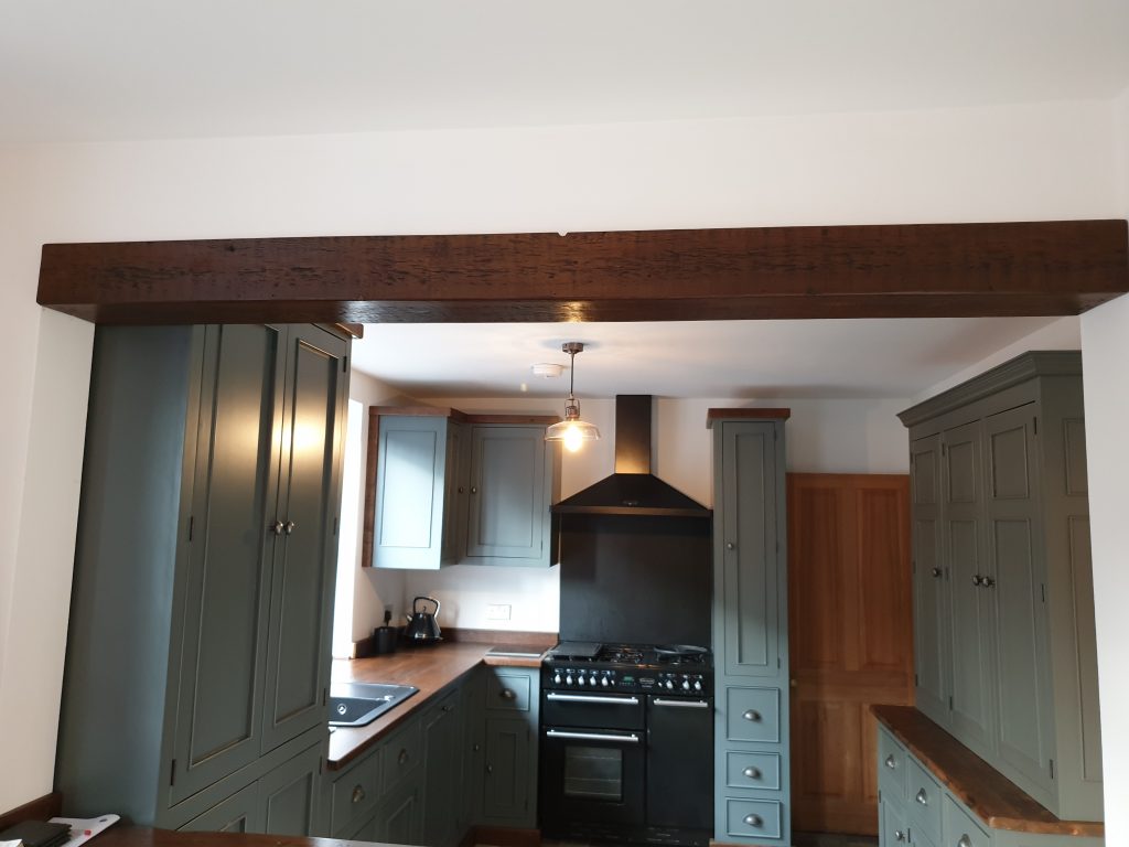 Bespoke kitchen with reclaimed wood beam in ceiling