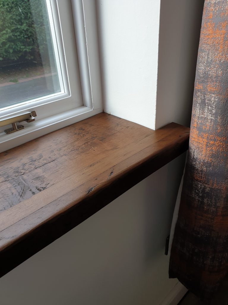 Close up of reclaimed wood window sills, finished as per Kitchen worktop