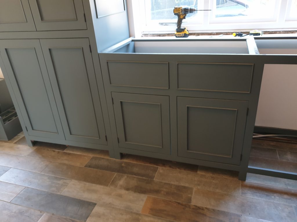 Reclaimed wood kitchen units for sink are installed awaiting sink and worktop