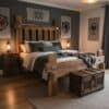 A unique, handcrafted medieval bed frame made from aged reclaimed wood with large hand-forged steel bolts and brackets.
