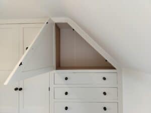The interior of a bespoke fitted wardrobe, showcasing various shelving and storage options